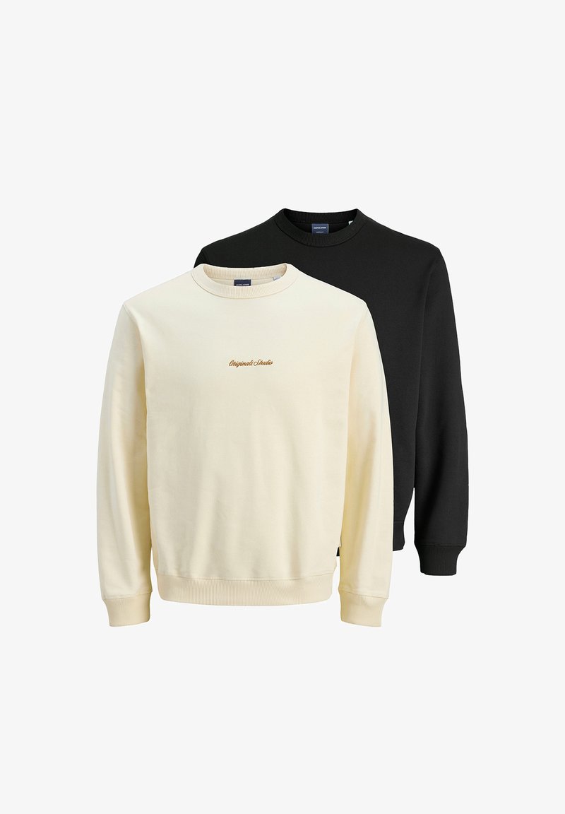 Due felpe con un design classico: una in crema con ricami delicati e una nera. Entrambe hanno colletto a giro e polsini a costine.