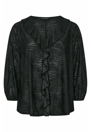 Blusa negra con un patrón de rayas de cebra texturizado, con volantes en el frente y mangas largas y abullonadas. Fabricada en un material ligero y transparente.