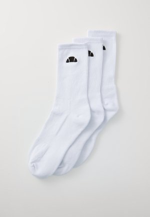 Chaussettes en coton blanc avec une texture côtelée, présentant un design de croissant noir dans la zone de la cheville. Trois paires incluses.