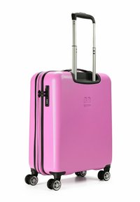 Valigia a mano rigida di colore rosa brillante, con superficie texturizzata, zip nere, manico estraibile e quattro ruote girevoli.