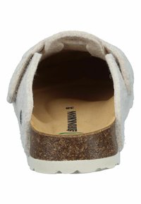 Beige slip-on sandal with felt upper, adjustable side straps, contoured cork footbed, and white textured rubber sole, viewed from the back.