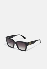 Black acetate sunglasses with a bold rectangular shape, gradient lenses, and gold logo accent on the temple. Matte finish.
