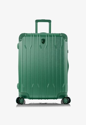 Grüner Hartschalenkoffer mit vertikalen Rillen, schwarzen Hardware-Akzenten, einem ausziehbaren Griff und vier Rädern. Die Oberfläche hat einen metallic Finish.