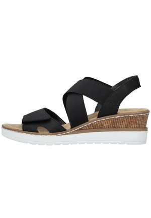Black wedge sandals with elastic cross straps, a cork-textured wedge heel, white rubber outsole, and a cushioned footbed.