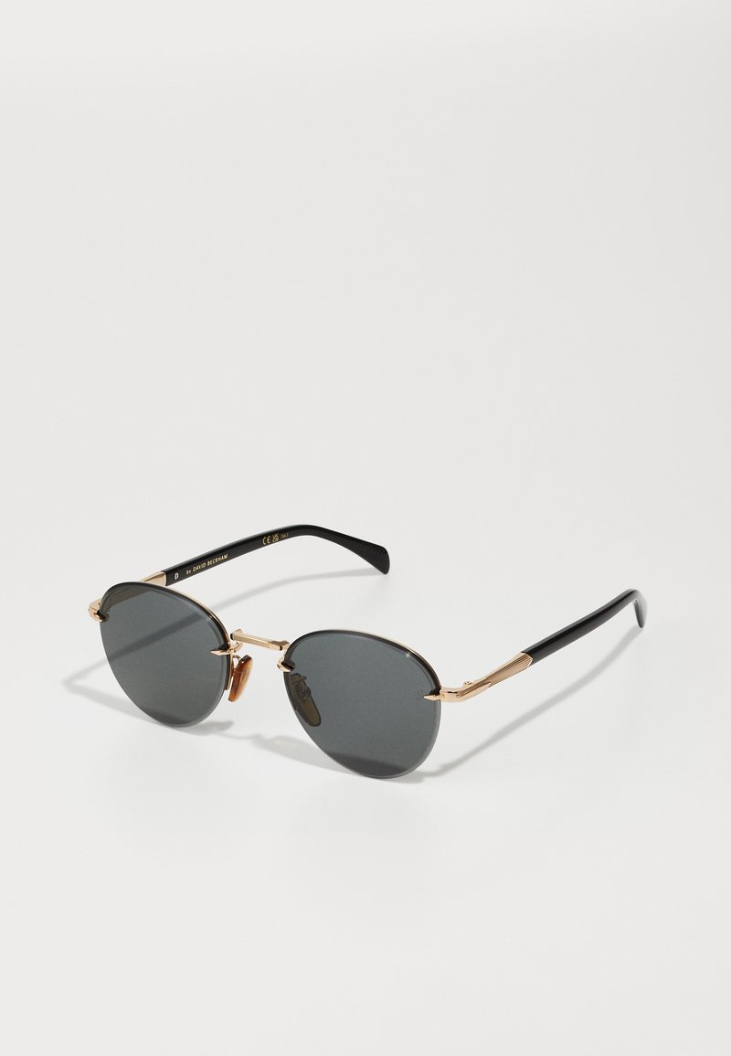 Round black sunglasses with dark tinted lenses, gold metal accents, and black plastic temples featuring a textured design at the hinges.