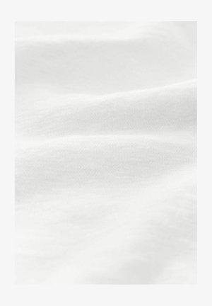 White cotton fabric with a smooth texture, showing soft folds and subtle variations in brightness. No patterns or visible hardware.
