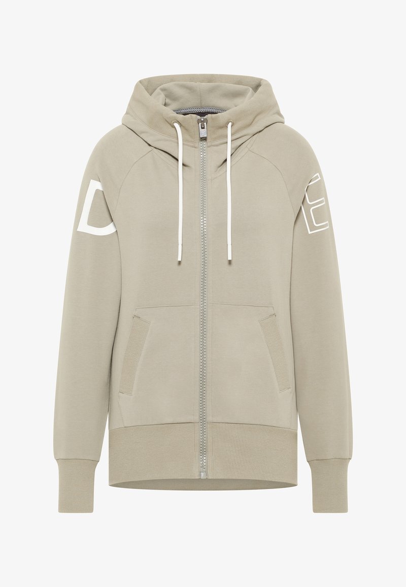 Cipzáros kapucnis pulóver világos bézs pamut keverékből, elülső zsebekkel, kapucnival és fehér nyomtatott betűkkel az ujjakon. Puha textúra, normál szabás.