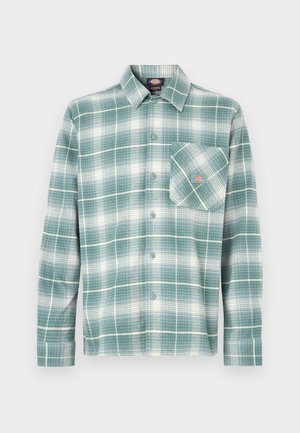 Zöld-fehér kockás flaneling. Gombos gallérral, hosszú ujjú, bal oldali mellzsebével.