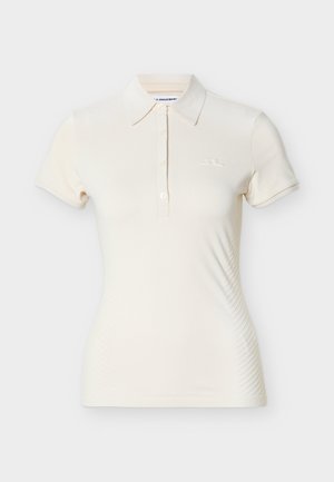 Kremowa koszulka polo z krótkim rękawem, z zapięciem na trzy guziki, kołnierzykiem, lekko dopasowanym krojem i subtelnym logo na lewej piersi.