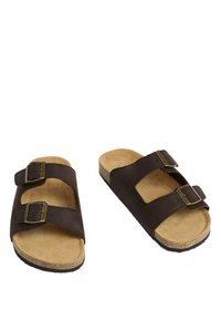 Sandalias de cuero marrón con dos correas ajustables de hebilla, una plantilla de corcho texturizado y una suela plana de goma suave.