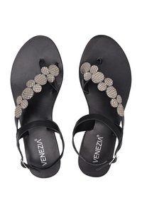 Zwarte leren sandalen met een teenstukontwerp, versierd met een decoratief patroon van beige ronde accenten. Verstelbare enkelband voor de juiste pasvorm.