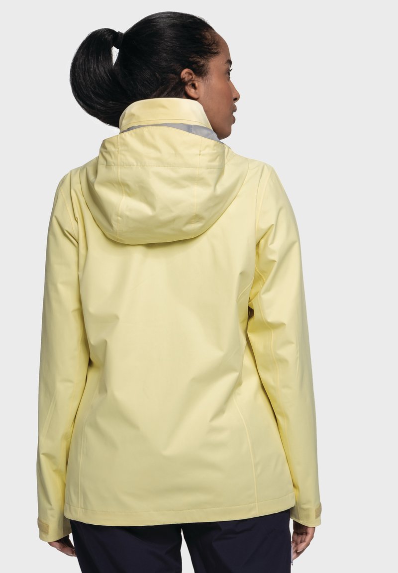 Lichtgele waterdichte jas met een capuchon, met nadenaccenten en elastische manchetten. Effen textuur, ontworpen voor buitenactiviteiten.