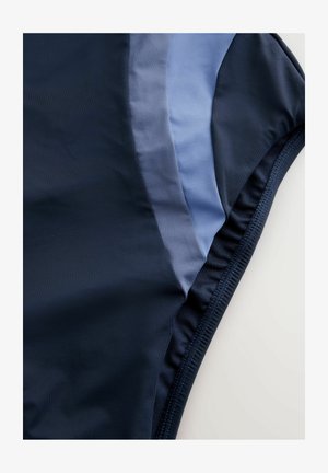 Navy swimwear featuring a smooth texture with light blue panels. The design includes elastic seams and a fitted shape.