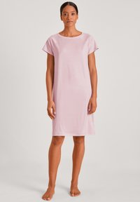 Short pink nightdress with a round neckline and short sleeves. Made from smooth, lightweight fabric, featuring a relaxed fit and knee-length cut.