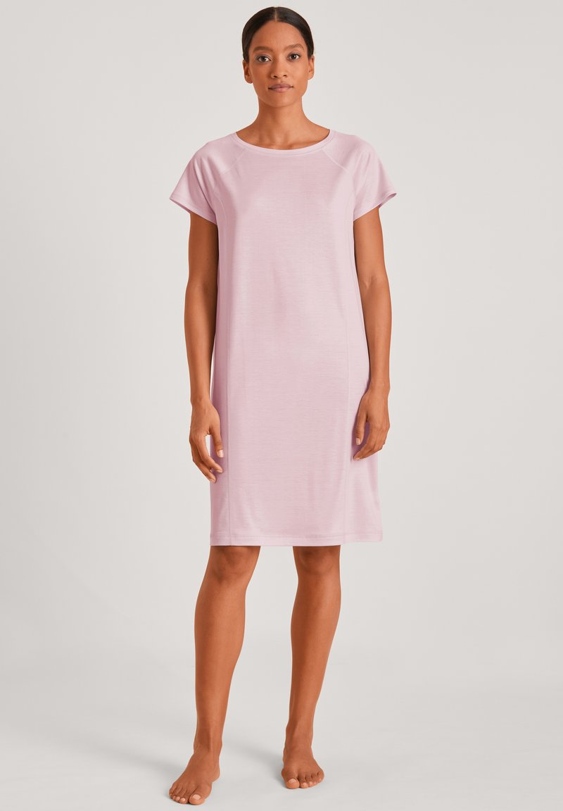 Short pink nightdress with a round neckline and short sleeves. Made from smooth, lightweight fabric, featuring a relaxed fit and knee-length cut.