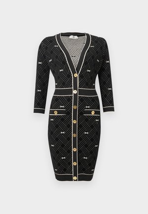 Mustast keha järgiv kampsunkleit kuldsete nööpidega, valgete geomeetriliste mustritega, pikkade varrukatega, kahe esite taskuga ja valge äärisega.