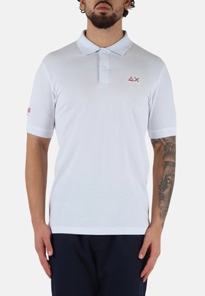 Polo bianco realizzato in misto cotone, con colletto classico, maniche corte e un logo rosso chiaro sul petto e sulla manica.