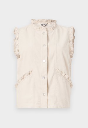 Gilet sans manches ivoire à boutons avec un bord volanté sur le col, les emmanchures et les poches, posé à plat sur un fond blanc.