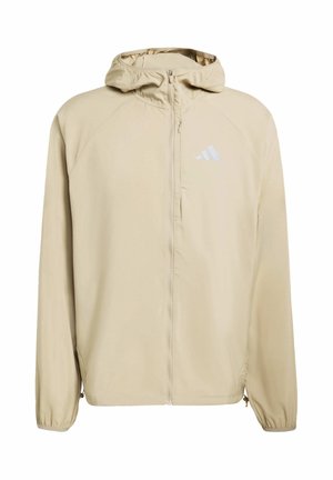 Beige hooded jacket with a full zip, made of smooth fabric; features raglan sleeves and a reflective Adidas logo on the chest.