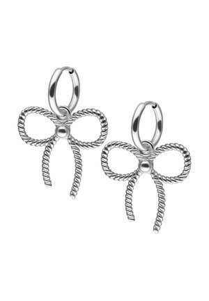Silver earrings shaped like a bow, featuring twisted wire design and a central bead. The metal has a polished finish.