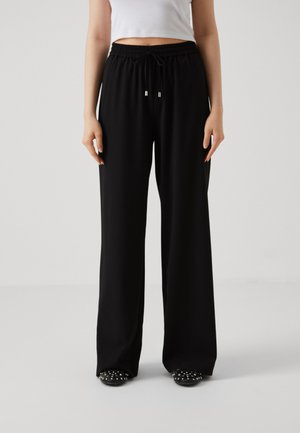 Black wide-leg pants made of soft fabric with an elastic waistband and drawstring. Smooth texture with a loose fit.