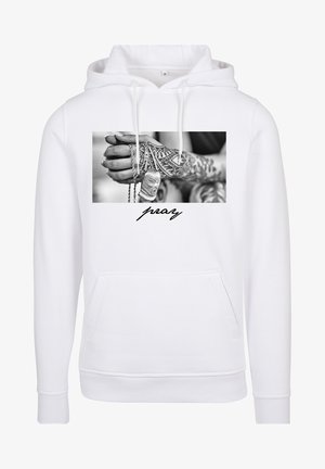 White hoodie with a front pocket, featuring a black and white graphic of hands with tattoos holding chains and a pendant, and "pray" text.