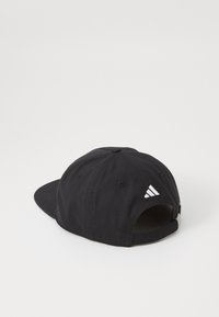 Black baseball cap made of fabric featuring a curved brim. Back shows adjustable strap with silver hardware and white brand logo detail.