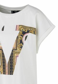 White short-sleeve t-shirt featuring a prominent black and gold patterned graphic with ornate designs and chain elements.