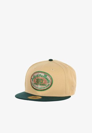 Khaki cap with a green flat brim. Features an embroidered patch with "Club" text and decorative stitching in green and gold accents.