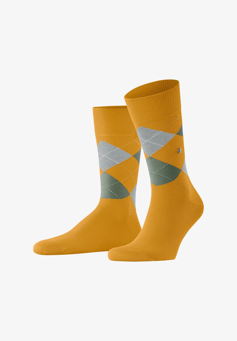 Skarpetki w pomarańczowo-szary wzór argyle z prążkowanymi mankietami, gładką teksturą oraz kontrastującymi diamentowymi kształtami na nogawkach.