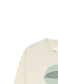 Sweatshirt couleur crème avec un motif rond en teal d'une tortue. Présente un col ribbé et des manches à poignets. Étiquette de matériau organique visible.