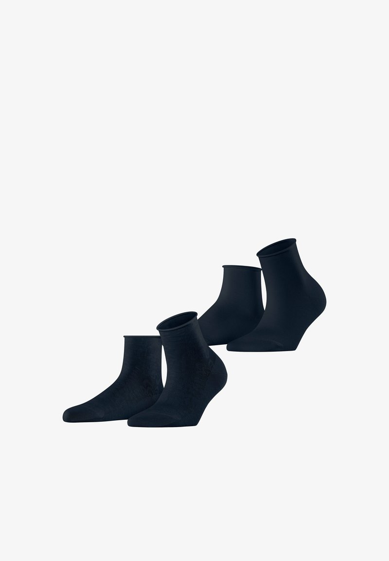 Quatre paires de chaussettes noires pour la cheville disposées en deux rangées sur un fond blanc, montrant les vues latérales et de face.