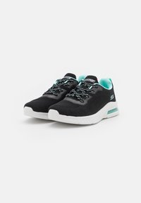Black athletic shoes with a textured upper, turquoise accents, and patterned laces. White midsole with a visible air cushioning unit.