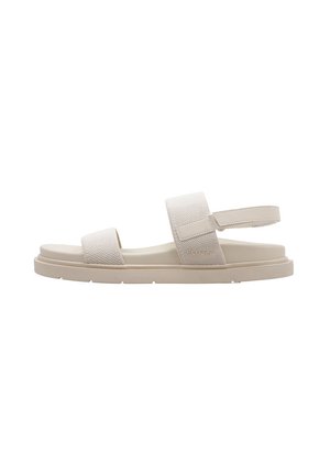 Sandales beige clair avec un dessus en maille texturée, sangle réglable et semelle épaisse. Design minimaliste. Convient pour un usage décontracté.