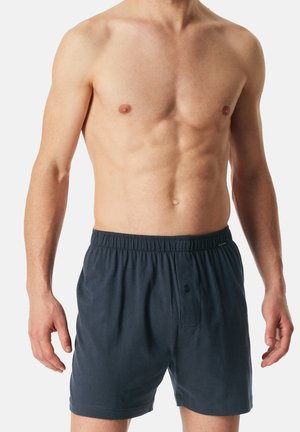 Marineblaue Baumwollboxershorts mit einem elastischen Bund, Knopfverschluss vorne und einer lockeren Passform. Einfaches Design ohne Muster oder Akzente.