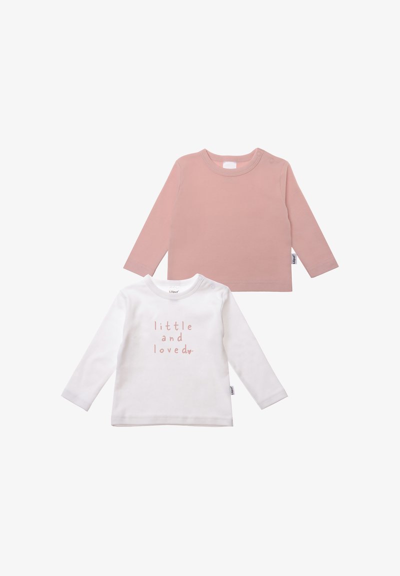 Two long-sleeve shirts: one in soft pink, the other in white with pink printed text "little and loved," crafted from cotton.