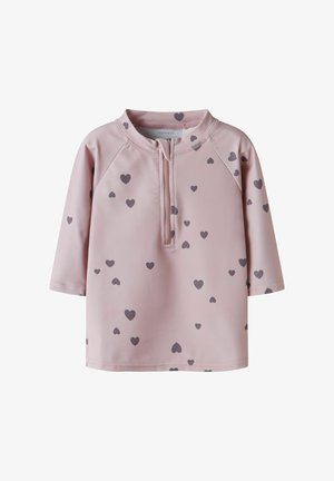 Világos rózsaszín hosszú ujjú kisgyermek póló elülső cipzárral és szórványos sötétszürke szívmintákkal.