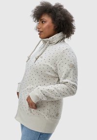 Sweat à capuche gris clair avec fermeture éclair, arborant un motif de petites formes colorées, des poches sur les côtés, ainsi que des poignets et un ourlet côtelés.