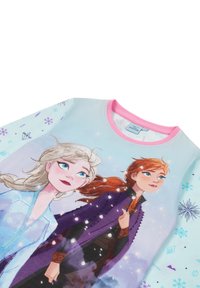 Light blue long-sleeve shirt featuring characters from Frozen, pink neckline, with snowflake and diamond pattern accents.