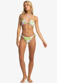 Bikini set featuring a multicolored top with pink and green floral patterns, tied sides on the bottom, made from stretchable fabric.