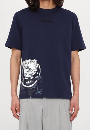 Navy blue T-shirt with small "ICEBERG" text near collar and a large white cartoonish monstrous face design on the lower left side.