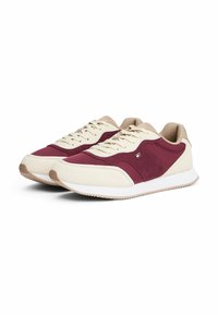 Burgundy and cream sneakers with a textured upper, lace-up design, padded collar, and rubber sole featuring contrasting accents.
