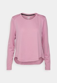 Långärmad atletisk topp i ljusrosa med en texturerad yta. Rundad nederkant, rund halsringning och kontrasterande axeldetaljer.