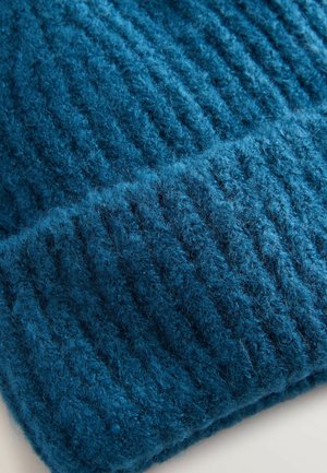 Blaues Strickmütze, aus dickem Wolle mit gerippter Textur. Verfügt über einen umgeschlagenen Saum für zusätzliche Wärme. Weicher und bequemer Look.
