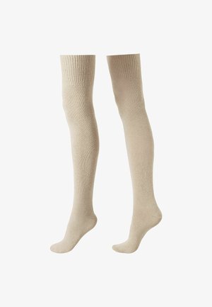 Chaussettes beige jusqu'aux genoux en tissu doux, avec un bord côtelé en haut et une texture lisse tout au long.