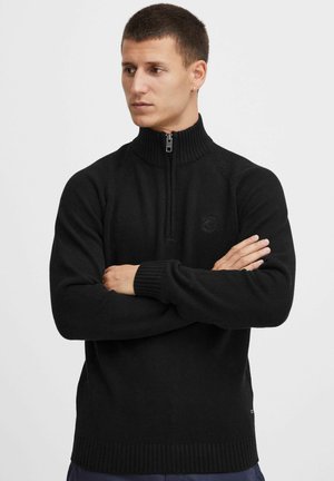 Schwarzer, mit Reißverschluss versehenen Halbreißverschluss-Pullover mit gerippten Bündchen und Saum. Gewebte Textur mit subtilem Logodetail auf der Brust.