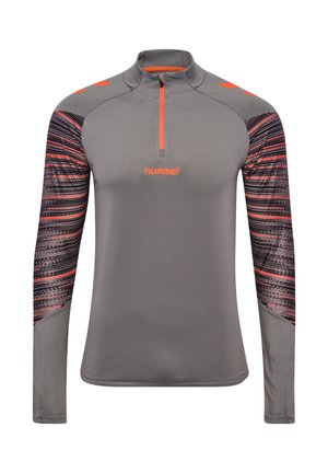 Grijze sporttop met lange mouwen, oranje accenten, patroon op de mouwen, rits aan de voorkant en het "hummel"-logo in het midden van de borst.