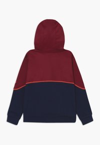 Hooded sweatshirt with long sleeves, color-blocked in burgundy on top and navy blue on bottom, featuring orange seam accents.