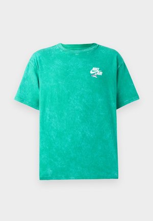 T-shirt verde com efeito tie-dye, feita de algodão. Apresenta um decote arredondado, mangas curtas e um pequeno logo branco da Nike Air na área do peito esquerdo.