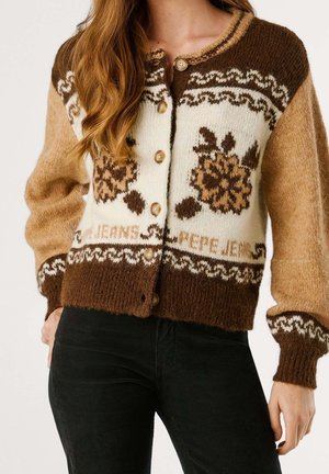 Bruin, beige en wit gebreid vest met bloemmotieven, knoopsluiting en "Pepe Jeans" tekst aan de voorkant, gedragen met een zwarte broek.